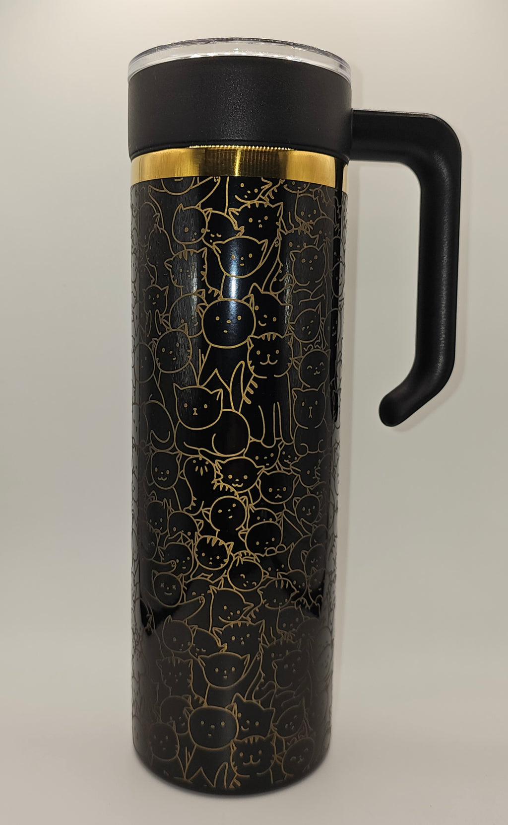 Black tumbler with cat pattern and gold accents on a white background