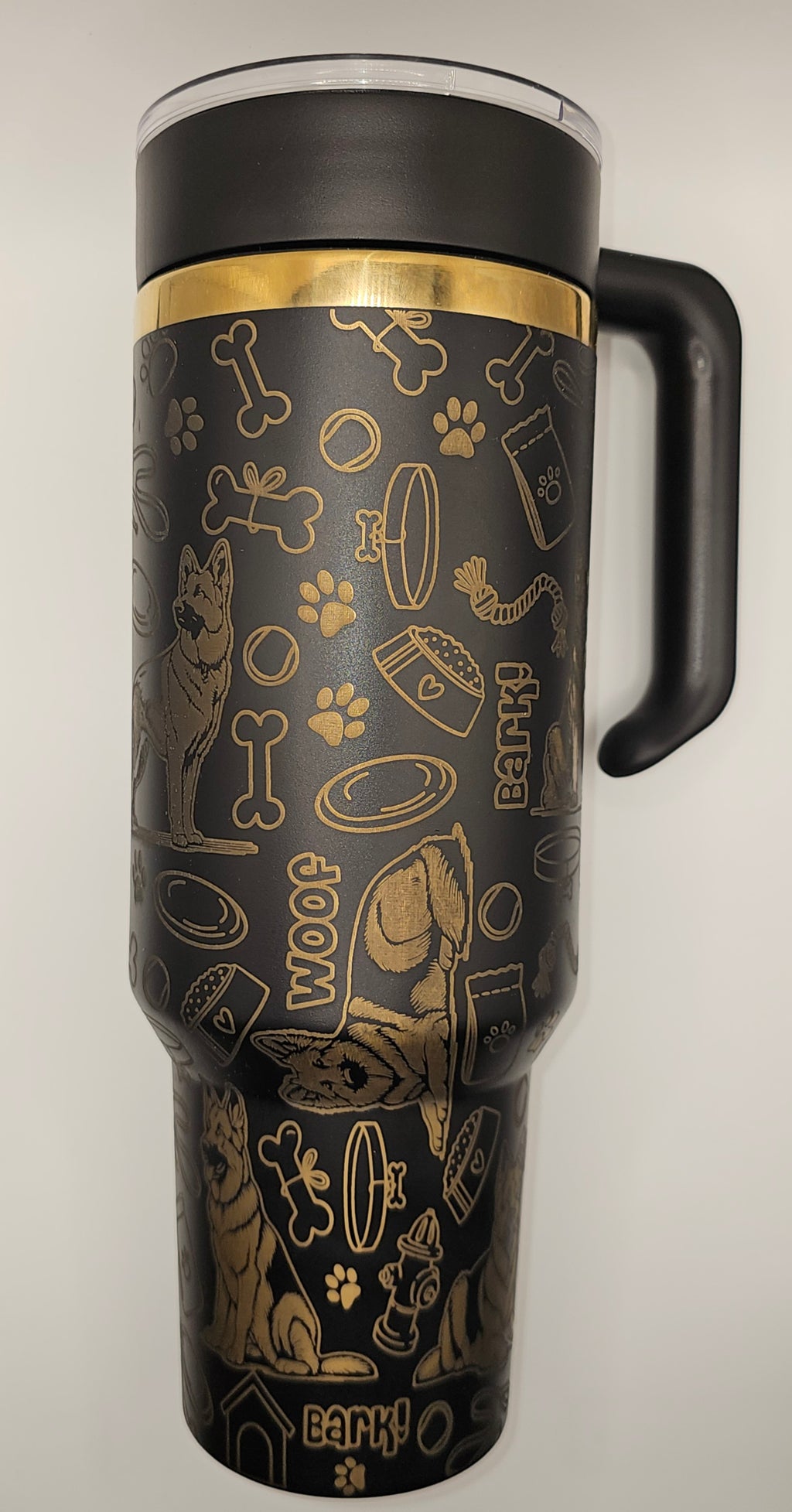 Black tumbler with gold animal-themed design on a white background