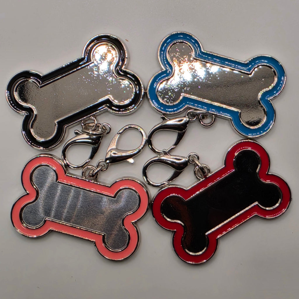 Four bone-shaped keychains in red, blue, pink and black