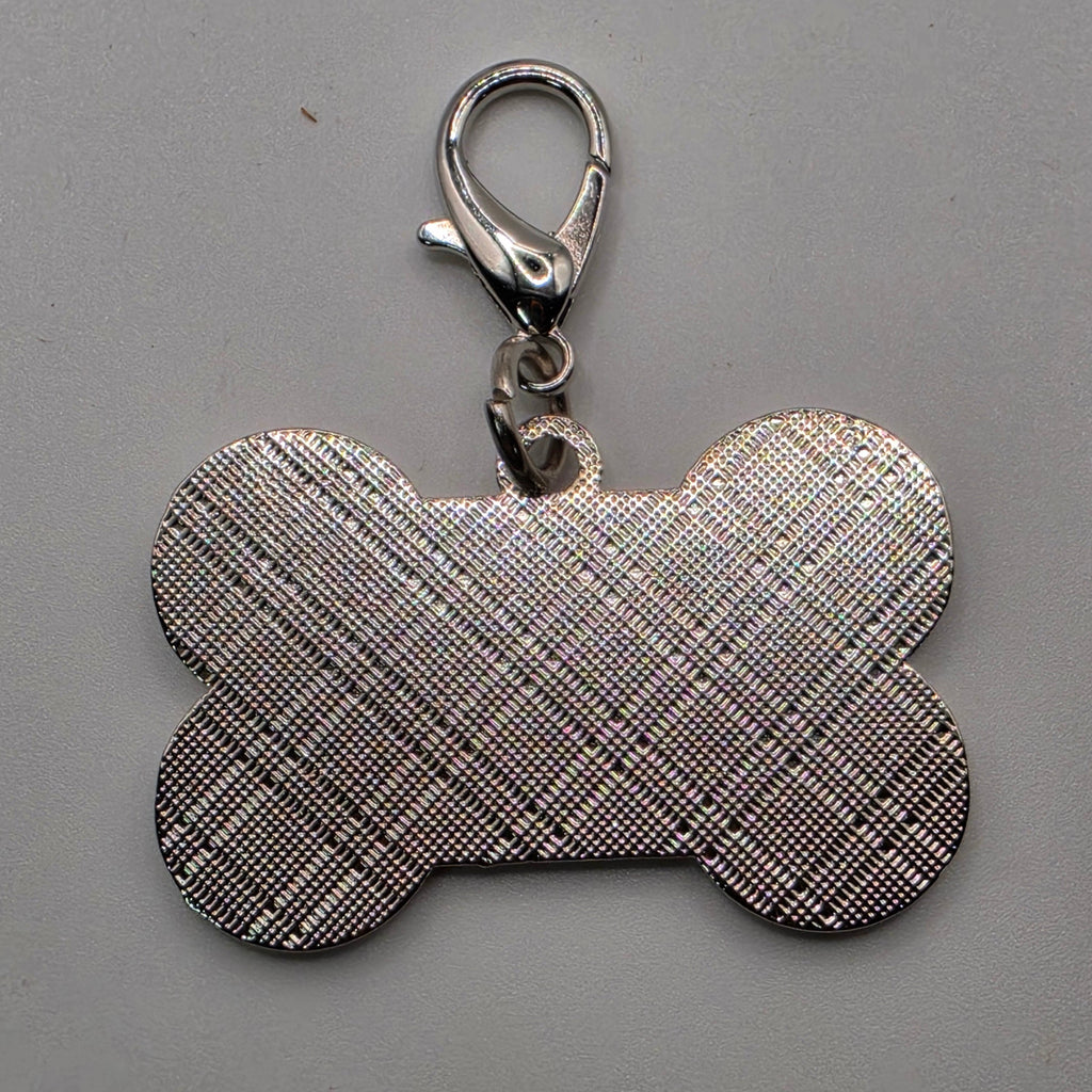 Dog bone-shaped keychain with plaid pattern on a gray background