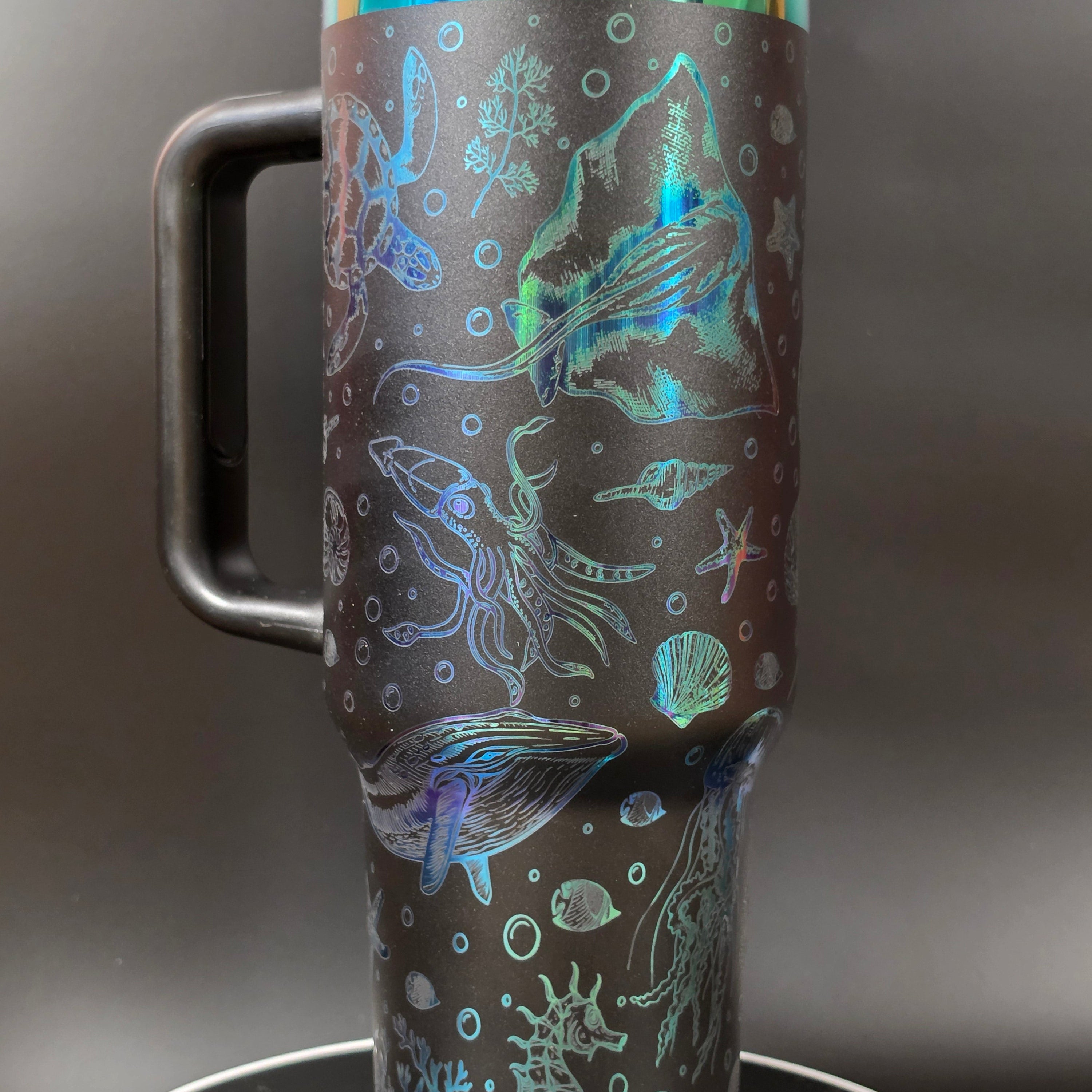 Close-up of a handlebar with a decorative wrap featuring marine life designs on a dark background.