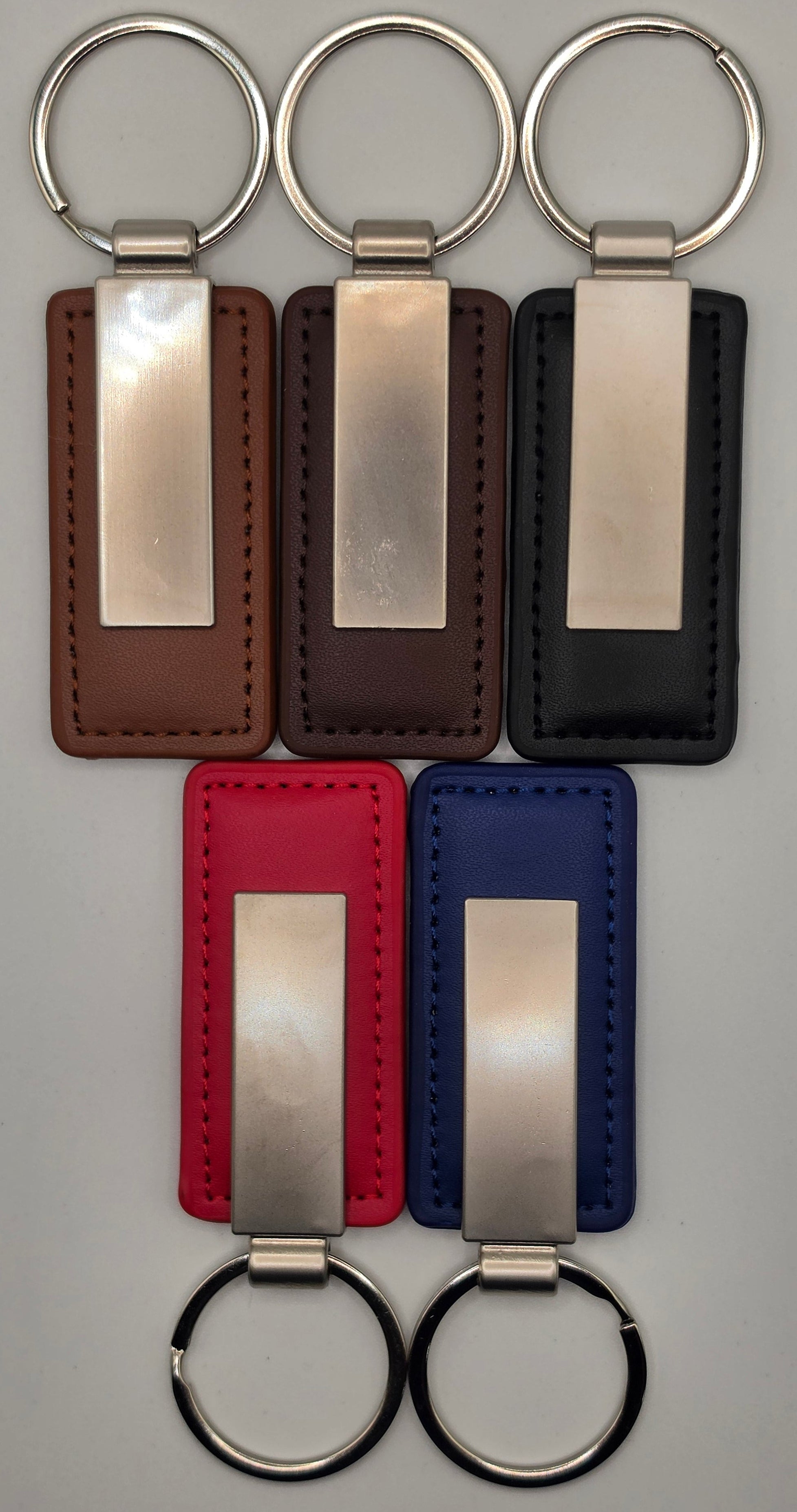 Set of keychains with metal tags on a gray background