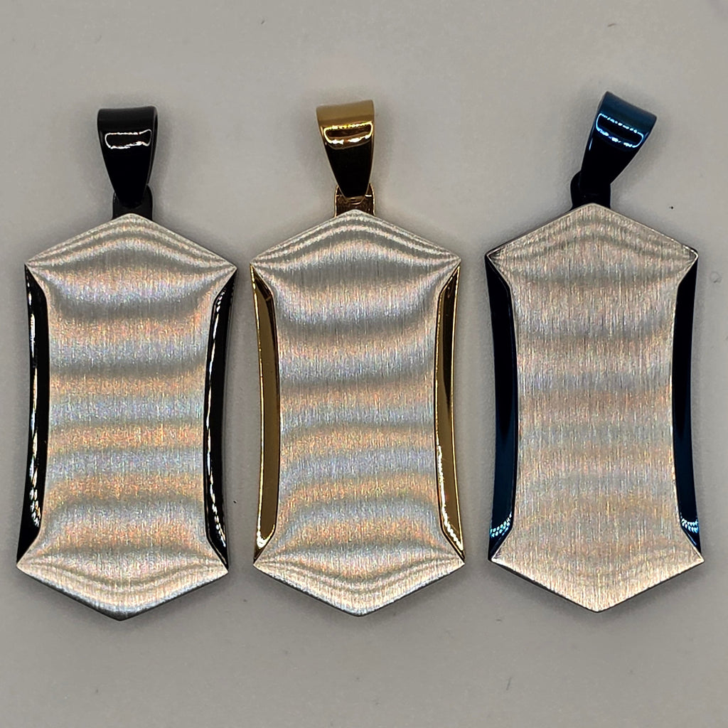 Three metallic hair clips on a gray background