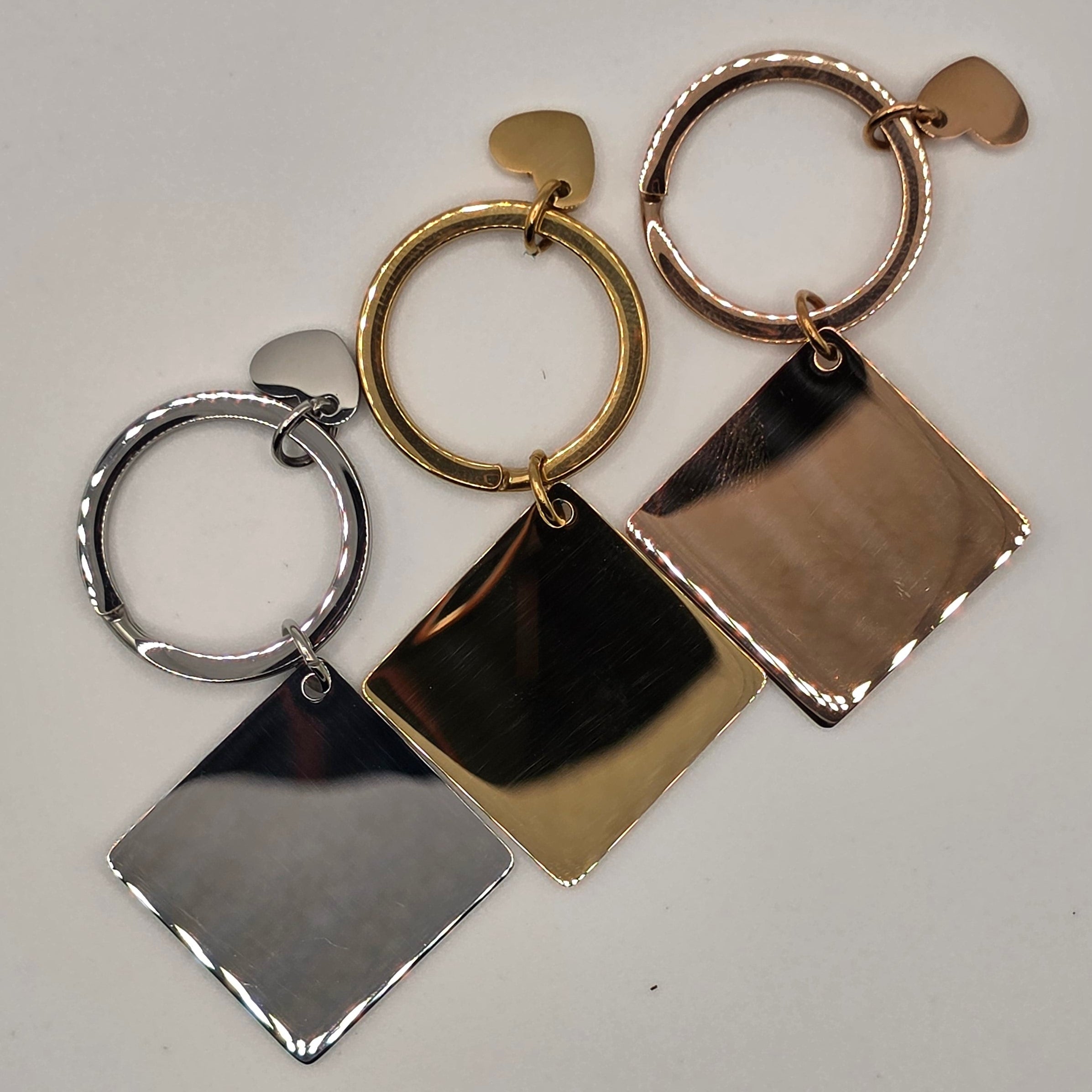Geometric keychain with gold, bronze, and silver shapes on a light gray background