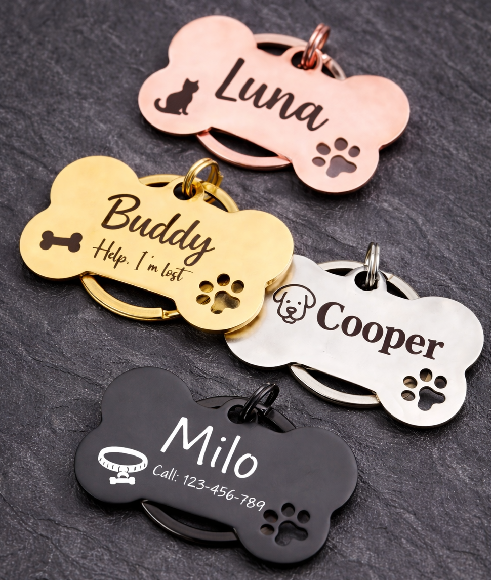Set of personalized dog tags with names engraved on a dark surface
