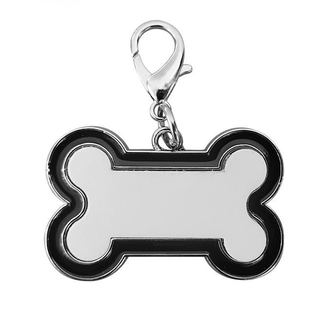 Bone-shaped pet tag with black border and silver clasp on a white background