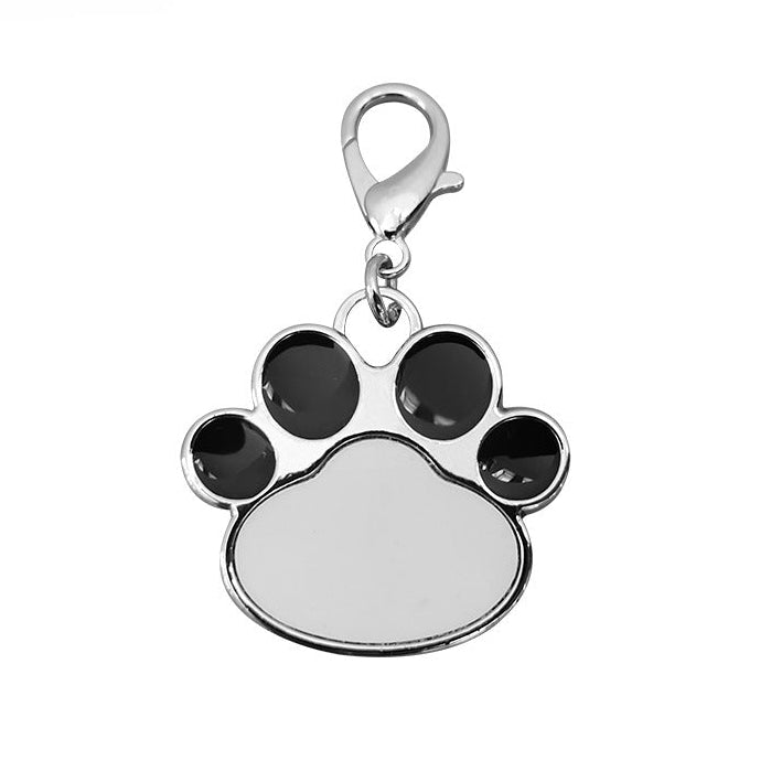 Paw print charm with black accents on a white background