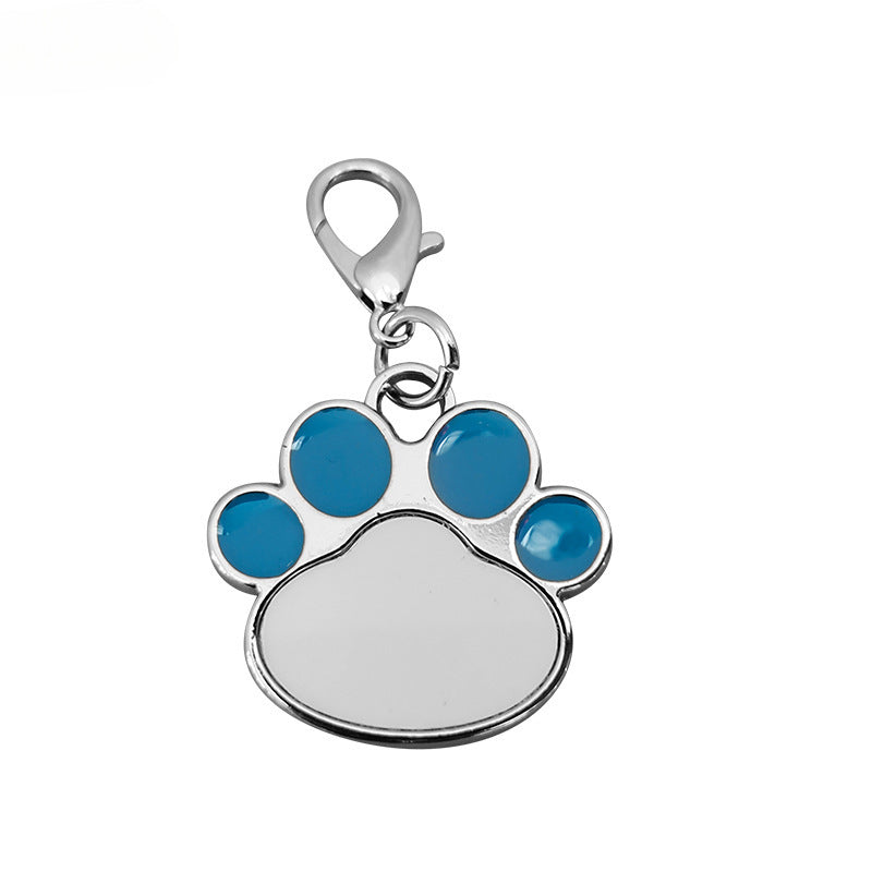 Paw print charm with blue accents on a white background