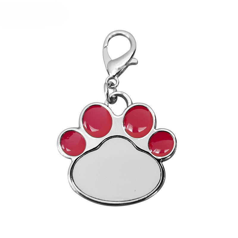 Paw print charm with red pads on a white background
