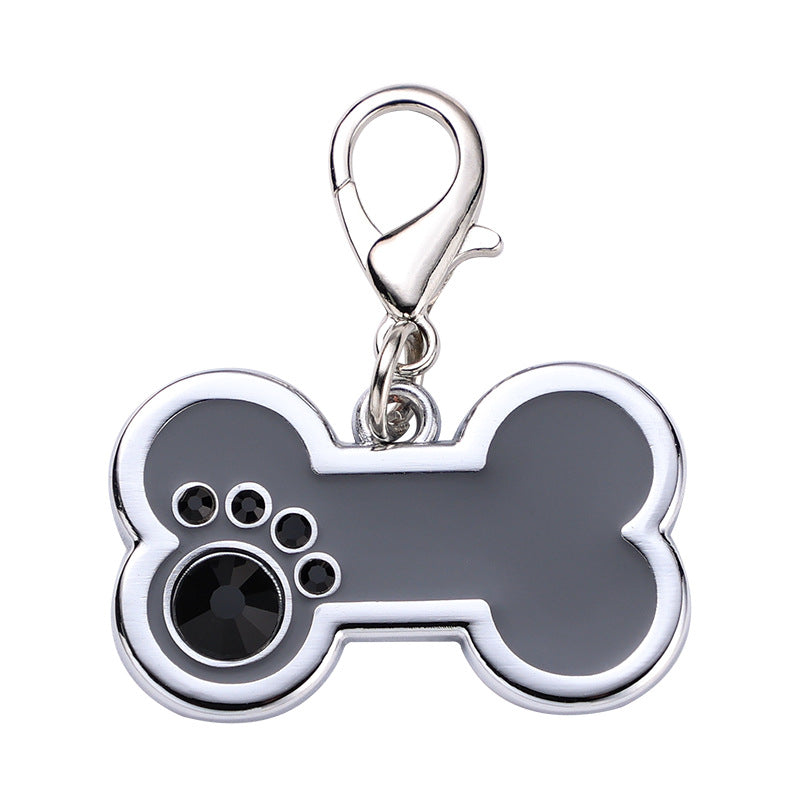 Bone-shaped pet tag with paw prints on a white background