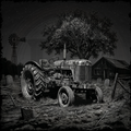 Vintage tractor in a field with a windmill and barn in the background