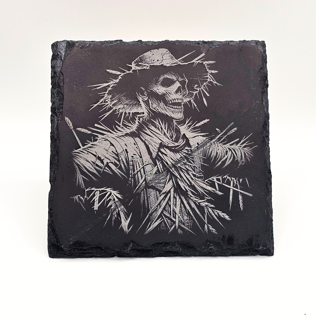 Slate coaster with a engraved skeleton design on a white background