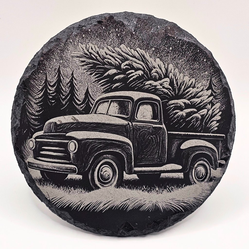 Decorative stone with a engraved image of a vintage truck and trees on a white background