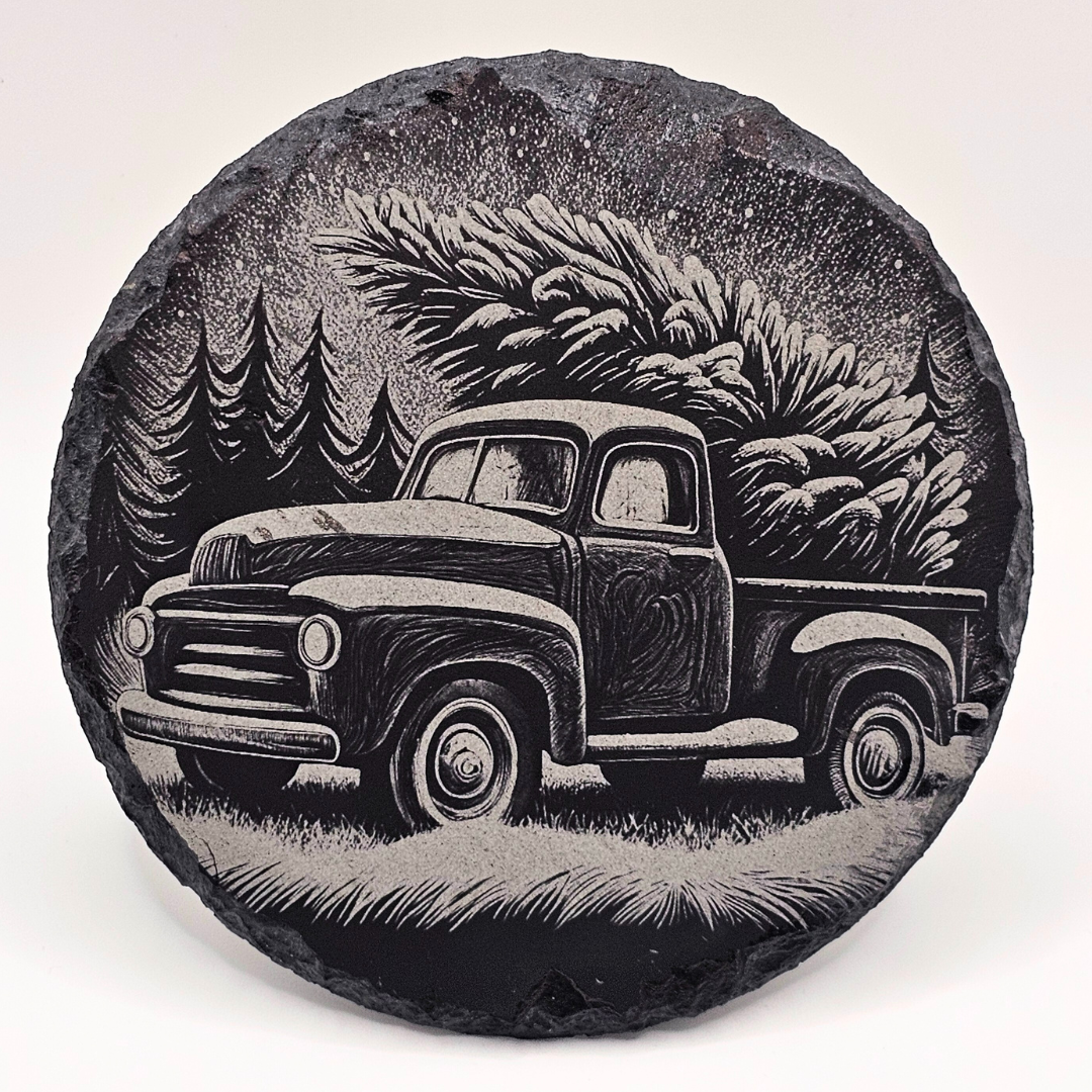 Decorative stone with a engraved image of a vintage truck and trees on a white background