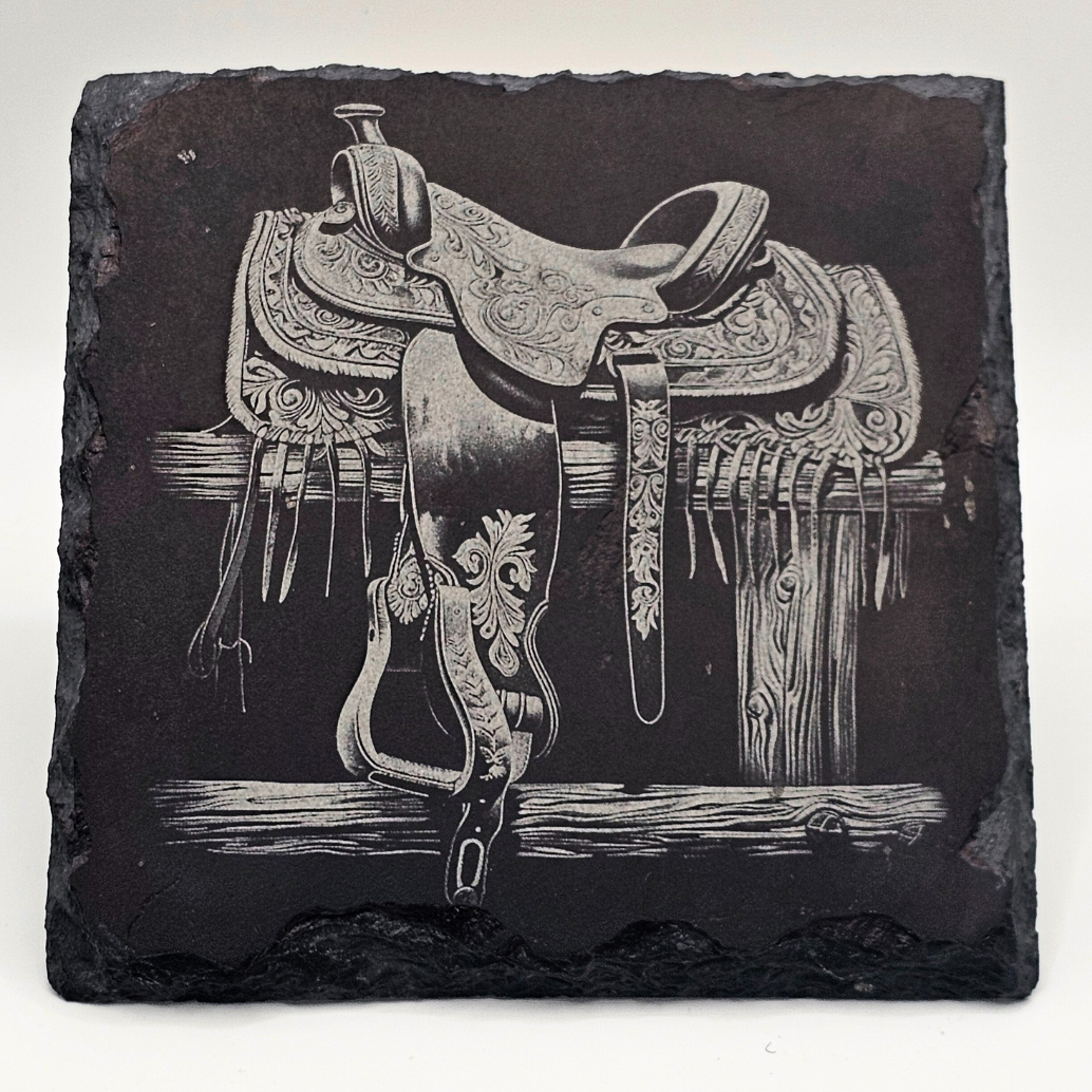 Decorative slate with a detailed illustration of a horse saddle and bridle on a white background