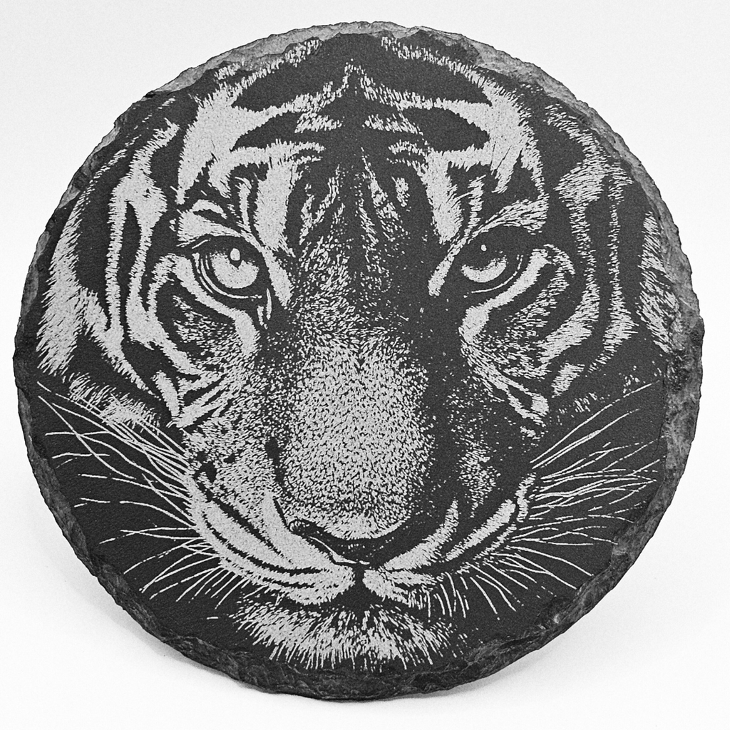 Round stone with a detailed engraving of a tiger's face on a white background