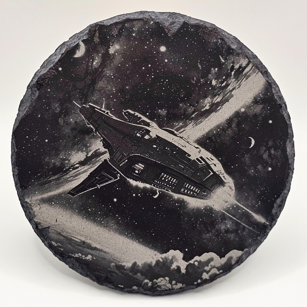 Round stone with a spacecraft design against a starry sky