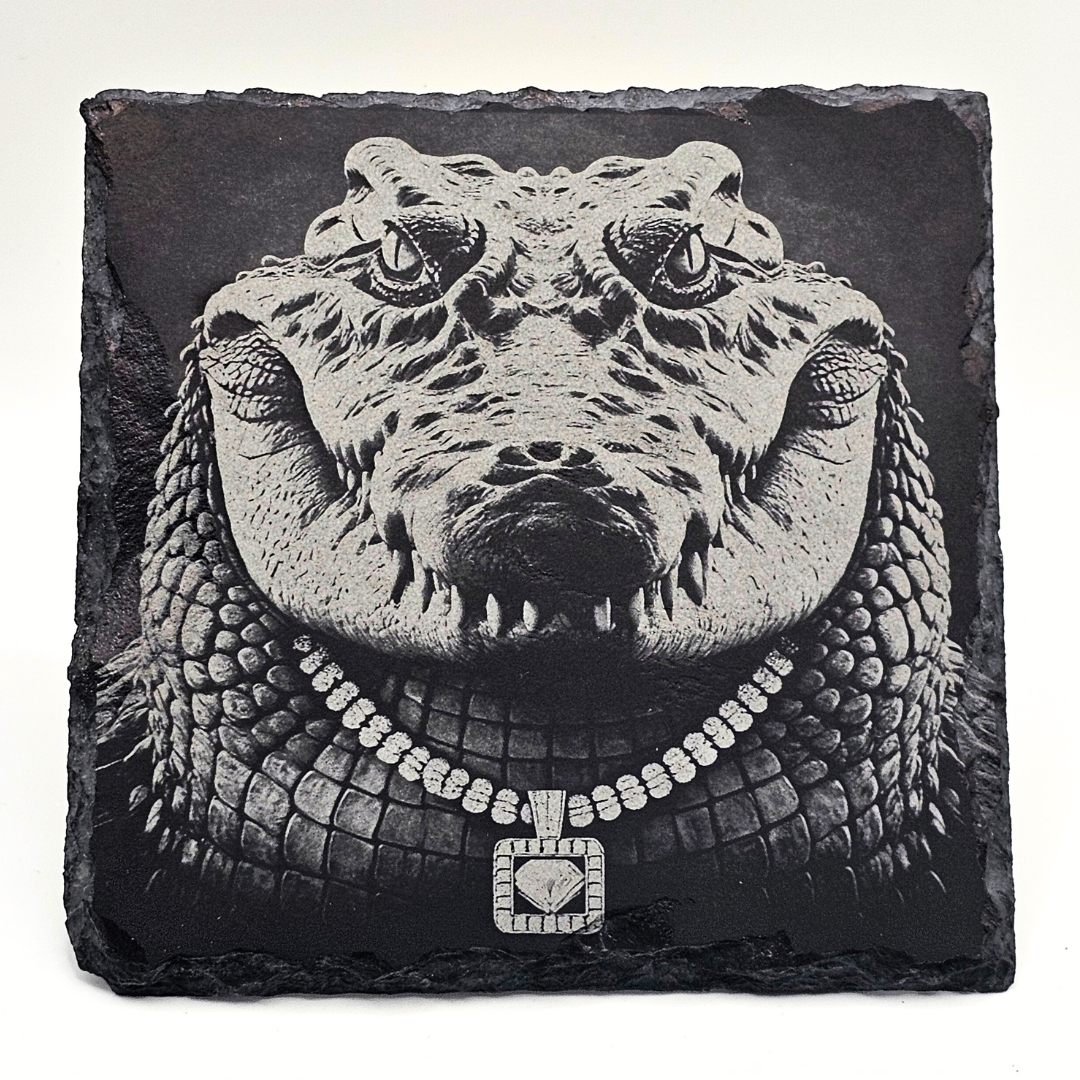 Carved stone alligator head wearing a diamond necklace on a black background