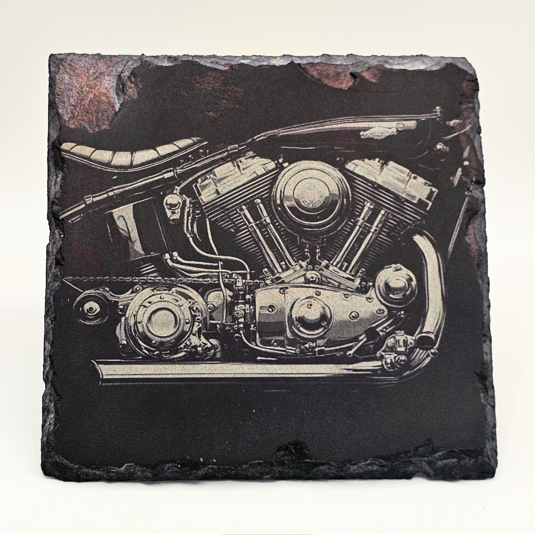 Slate coaster with engraved motorcycle engine design on a white background