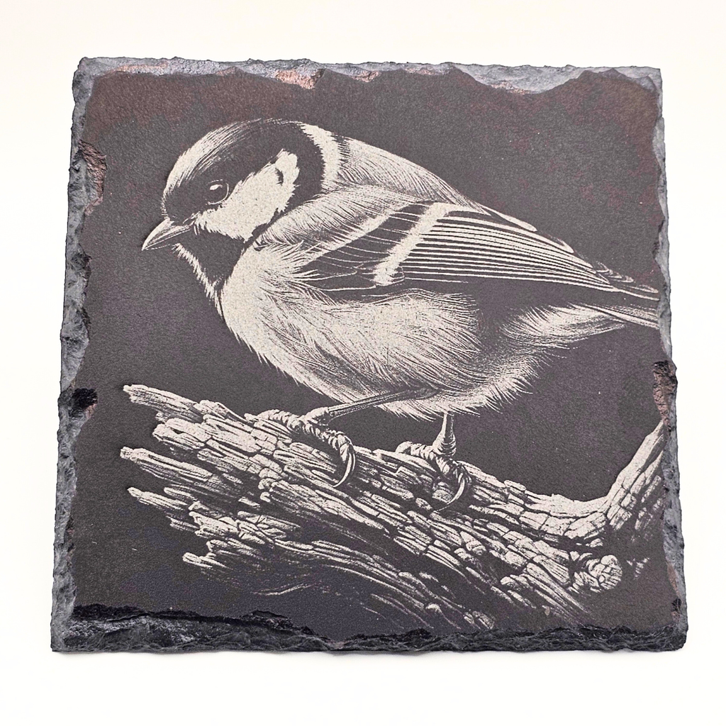 Slate coaster with a bird design on a white background