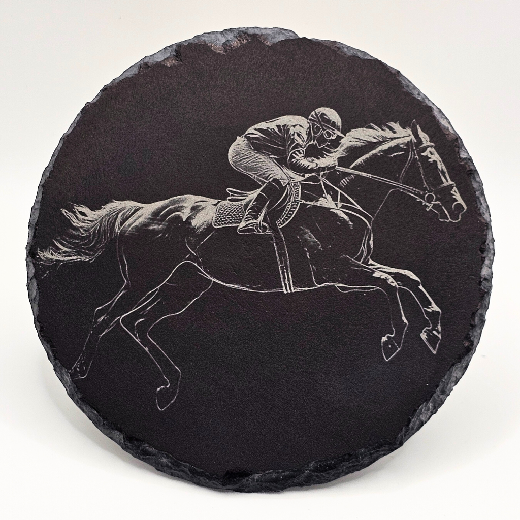 Black slate coaster with engraved image of a horse and jockey on a white background