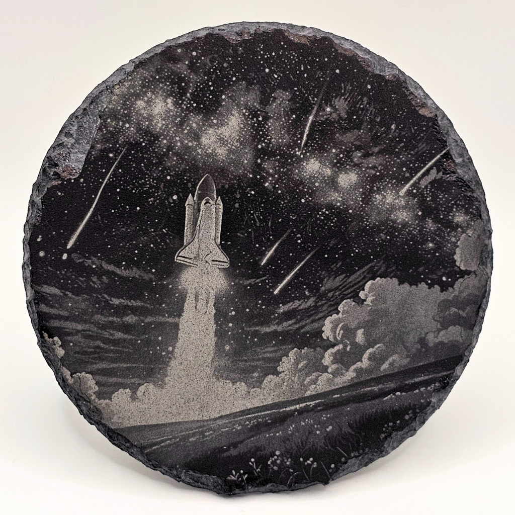 Decorative stone with a space shuttle launch design against a starry night sky.