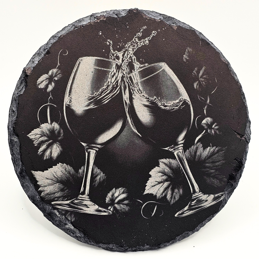 Round slate coaster with engraved design of two wine glasses and leaves.