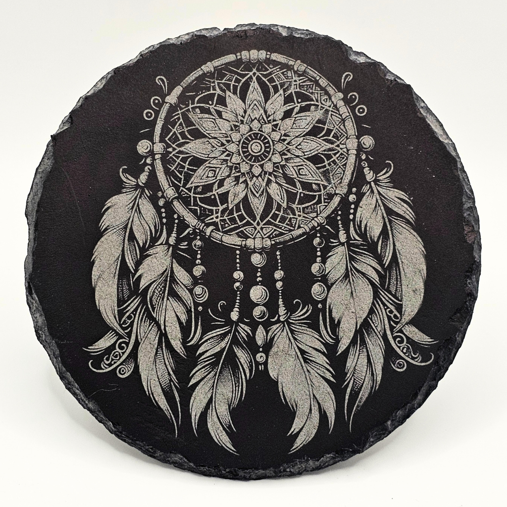 Round slate coaster with a detailed black and white dreamcatcher design on a white background