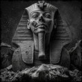 Black and white image of a sphinx with a starry sky background