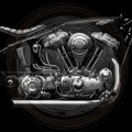 Close-up of a motorcycle engine with intricate details on a black background