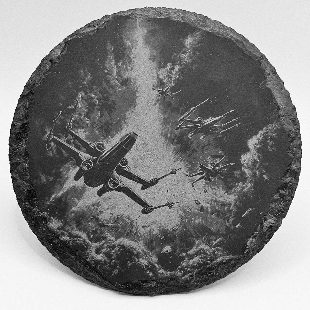 Decorative stone with engraved image of space ships on a white background