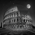 Black and white image of the Colosseum under a starry night sky with a moon.