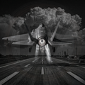 F-35 fighter jet taking off with a dramatic cloud formation in the background.