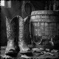 Cowboy boots next to a barrel and glass of wine on a wooden surface.