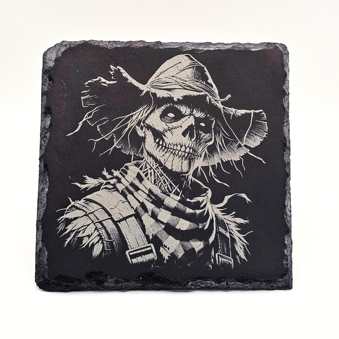 Slate coaster with a black and white illustration of a skeleton scarecrow on a white background
