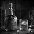 Decorative whiskey decanter with a glass of whiskey and ice cubes on a wooden surface.