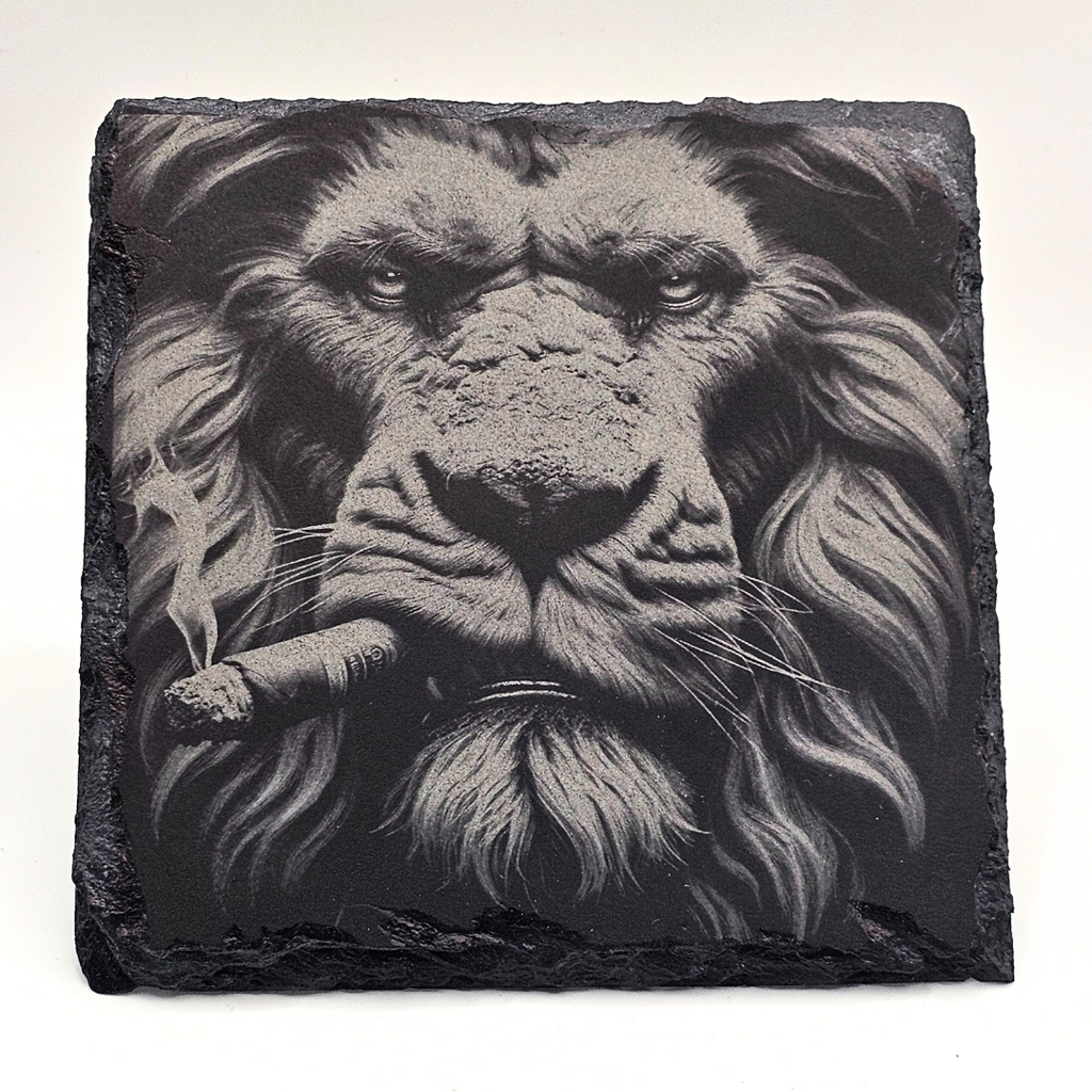 Slate stone with a detailed black and white lion's face on a white background