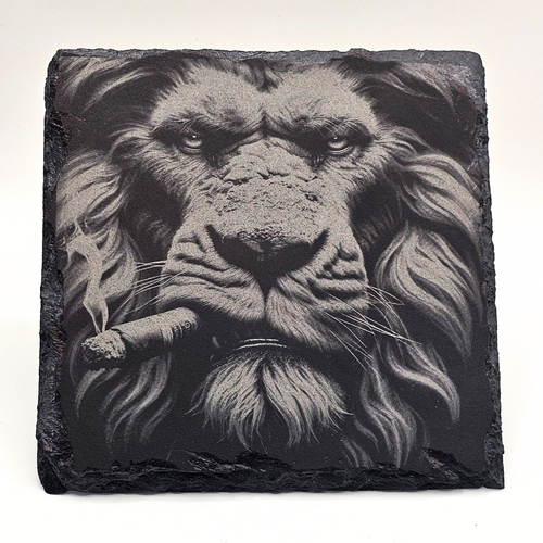 Slate stone with a detailed black and white lion's face on a white background