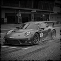 Porsche race car on a track with a blurred background
