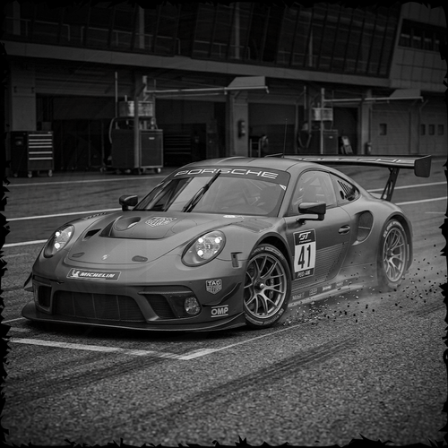 Porsche race car on a track with a blurred background