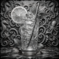 Decorative glass with a lemon slice and mint leaves against a decorative wall.