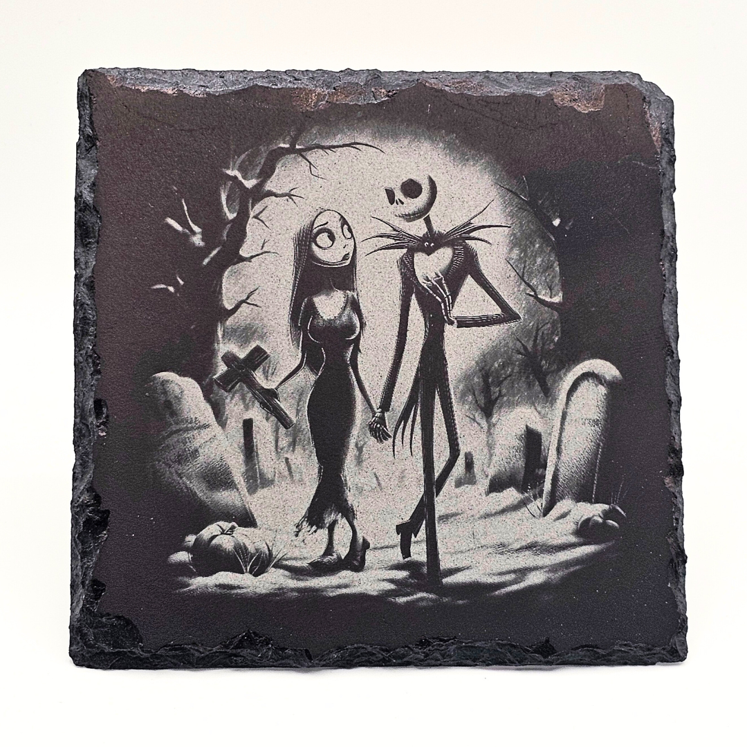 Decorative slate with Jack Skellington and Sally from 'The Nightmare Before Christmas' in a cemetery setting.