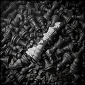 Close-up of a pile of chess pieces with a white star on a black background
