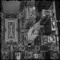 Aerial view of a cityscape with tall buildings and roads.