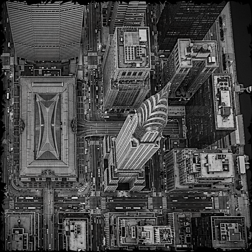 Aerial view of a cityscape with tall buildings and roads.
