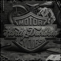 Harley-Davidson logo with a vintage motorcycle and tools in the background