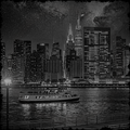 City skyline at night with a ferry boat on the water