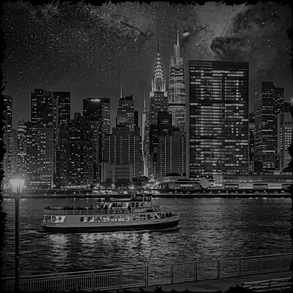 City skyline at night with a ferry boat on the water