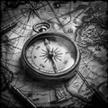 Vintage compass on an old map with a black and white color scheme