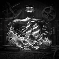 Decorative bottle with a ship and wave design on a dark background